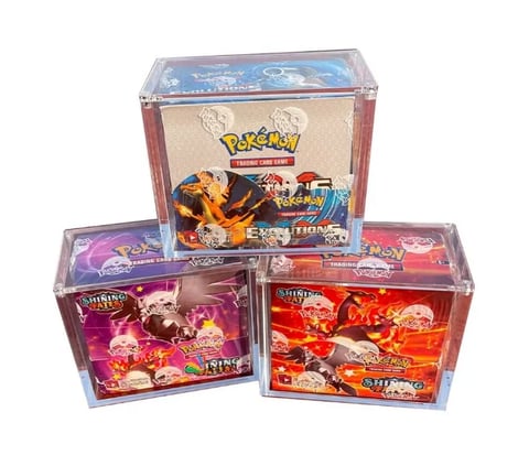 Three Pokemon Trading Card Game booster boxes arranged in a triangle, featuring colorful character artwork and packaging
